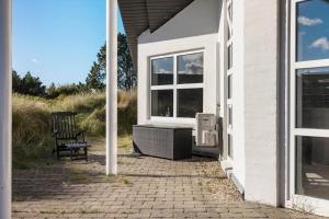 a chair sitting on a patio next to a house at 984-Thisted-Astien-4 in Torsted