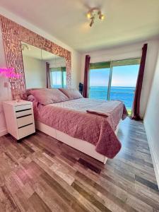 a bedroom with a bed and a large mirror at Ocean Soul Apartment in Santa Cruz de Tenerife