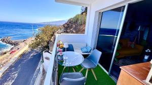 a balcony with a table and chairs and the ocean at Ocean Soul Apartment in Santa Cruz de Tenerife