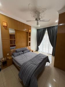 a bedroom with a bed and a ceiling fan at Majestic Bungalow Seberang Jaya in Perai +18 photos