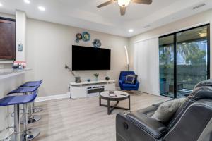 a living room with a flat screen tv at Luxury Oasis - Fresh impovements, Pool & Patio in Cape Coral
