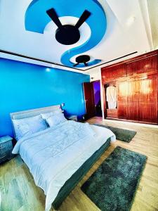 a bedroom with a large bed with a blue wall at Rabat sidi yahya zaër in Sidi Yahia az Zaʼer +11 photos
