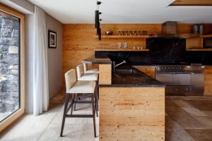 a kitchen with a counter with a bar with stools at Regent Retreat in Rougemont