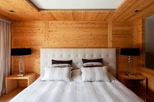 a bedroom with a white bed with two lamps at Regent Retreat in Rougemont +14 photos