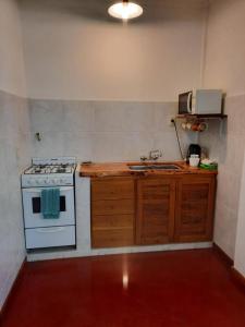 a kitchen with a stove and a sink at El Portal del Lago in Lago Puelo