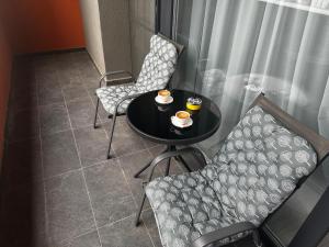 a small table with two chairs and two cups on it at Great View & Parking - Harmony Premium Residence in Timişoara