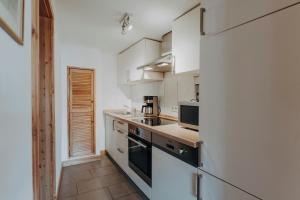 a kitchen with white cabinets and a stove at Apartments in der Blocksquerstraße in Lübeck