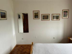 a bedroom with a bed and pictures on the wall at Hiša p'r Kobalu in Idrija +12 photos