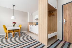 a small kitchen and dining room with a table and chairs at Your Holidays Bel Mare 407D in Międzyzdroje