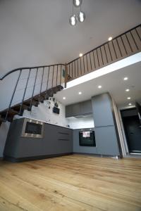 an empty room with a staircase and wooden floors at KgB - 32, Stylish City Apartment - 10 mins walk to Old Town in Vilnius