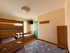 a room with two bunk beds and a tv at U Gosa in Ustronie Morskie
