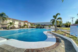 a swimming pool at a resort with palm trees at Angeles Palace Hotel in Angeles