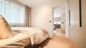 a bedroom with a bed and a large window at Riia street apartment with parking in Tartu