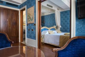 a bedroom with a bed and a glass table at Art Hotel Orologio in Bologna +37 photos