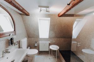 a bathroom with a sink and a toilet and a window at Apartment Klara in Lübeck