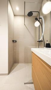 a bathroom with a sink and a shower at Riia street apartment with parking in Tartu