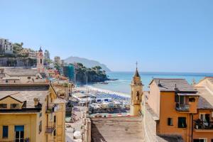 a view of a city with a beach and buildings at Newly Renovated Ocean View Flat in Sori