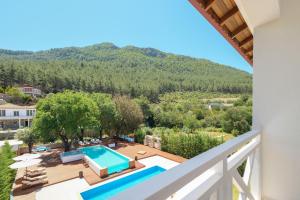 a villa with a swimming pool and a mountain at Tütsü Suites in Eskiömerler