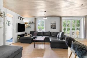 a living room with a couch and a table at 100-Thisted-Kapelvej-1 in Thisted
