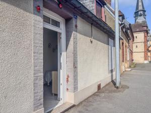 an open door of a building with a street at Le studio de saint jean in LʼAigle