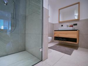 a bathroom with a shower and a sink and a mirror at BLACKSTYLE - AlpenLuxus Collection in Brixlegg +29 photos