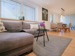 a living room with a couch and a table with flowers on it at BLACKSTYLE - AlpenLuxus Collection in Brixlegg +29 photos