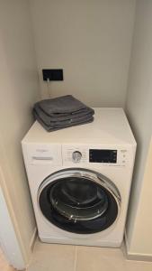 a washing machine with a towel on top of it at Riia street apartment with parking in Tartu