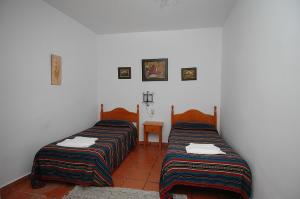 Postel nebo postele na pokoji v ubytování Apartamentos Turísticos Rural Los Tinaos