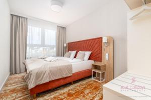 a bedroom with a large bed and a large window at Your Holidays Bel Mare Aqua F109 in Międzyzdroje +31 photos
