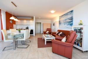 a living room with a couch and a table at Haus "Panorama" Appartement PAN063 in Duhnen