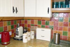 a kitchen counter with a coffee maker on a counter top at Carol Cottage & Master Suite - Mourne Mountains in Kilkeel +22 photos