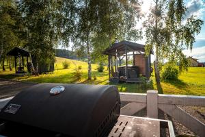 a barbecue grill and a gazebo in a yard at Ptaszkova PrzyStań in Ptaszkowa