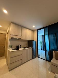 a kitchen with a sink and a refrigerator at Patong Beach Apartment Lux in Patong Beach