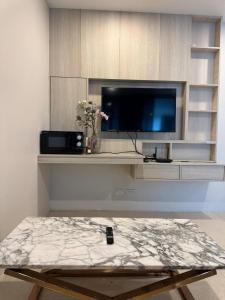a remote control sitting on a table in a living room at Patong Beach Apartment Lux in Patong Beach
