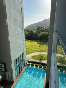 an external view of a building with a swimming pool at Patong Beach Apartment Lux in Patong Beach