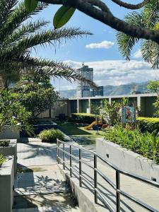 a view of a building with a fence and trees at The Monroe at Horizons 101 in Cebu City