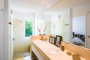 a bathroom with two sinks and a large mirror at Exclusive 5 Bedroom Villa in Ibiza City, 1266 in Cala Llonga +48 photos