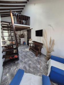 a living room with a spiral staircase and a couch at Apto Beija Flor - Gran Capacidad in Villa de Leyva +13 photos