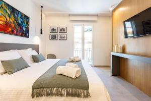 a bedroom with a large bed with a tv on the wall at Capo D'Amuri in Palermo