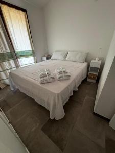 Ένα ή περισσότερα κρεβάτια σε δωμάτιο στο Casa vacanze Solanas +3 φωτογραφίες