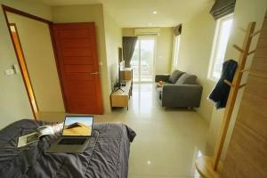 a room with a bed with a laptop on it at The Two bedrooms Two bathrooms in Phuket Old Town in Phuket