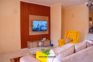 a living room with a couch and a yellow chair at Kristina Gardens in Voi