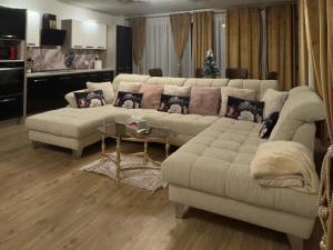 a living room with a couch and a table at Apartament RYO in Şelimbăr