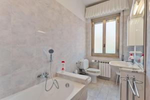 a bathroom with a tub and a sink and a toilet at Lerici sea view private parking best position in Lerici +21 photos