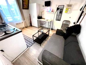 a living room with a couch and a kitchen at Stay in Montmartre in Paris