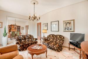 a living room with couches and a flat screen tv at Lerici sea view private parking best position in Lerici