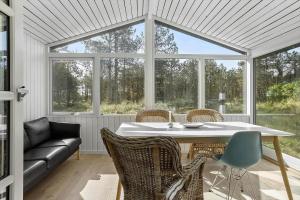 a conservatory with a table and chairs and a couch at 788-Thisted-Blamunkevej-46 in Thisted +13 photos