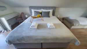 a bedroom with a large bed with towels on it at Holiday home Vinovilla in Kutjevo