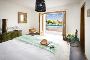 a bedroom with a bed with a hat on it at Modern 5 Bedroom Villa in Selva, 1455 in Selva +16 photos