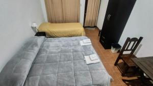 a small bedroom with a bed and a chair at Tampu 2 alojamiento in Purmamarca
